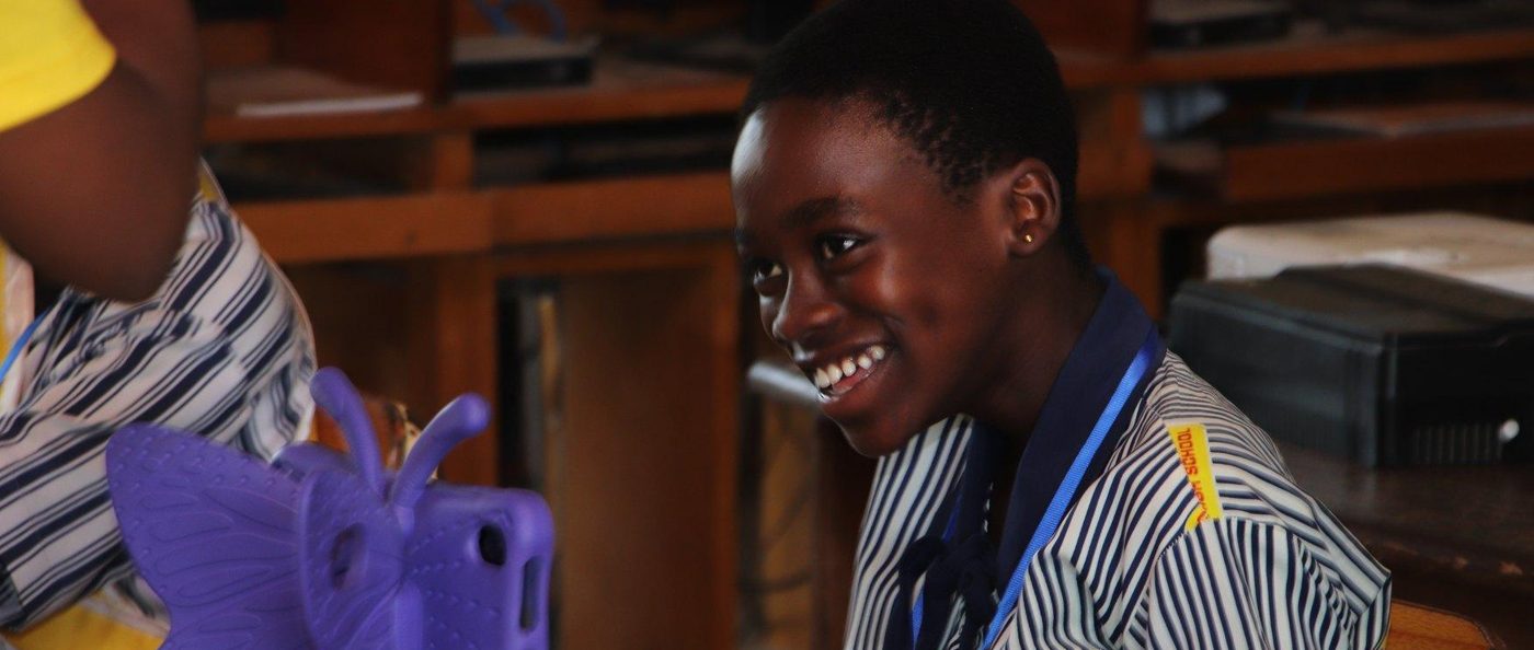 A learner smiling while reading during the Quiz